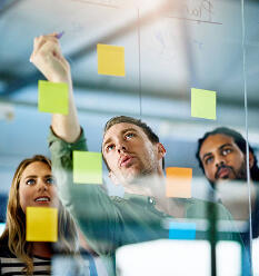 Business team reviewing financial strategy together at a planning board